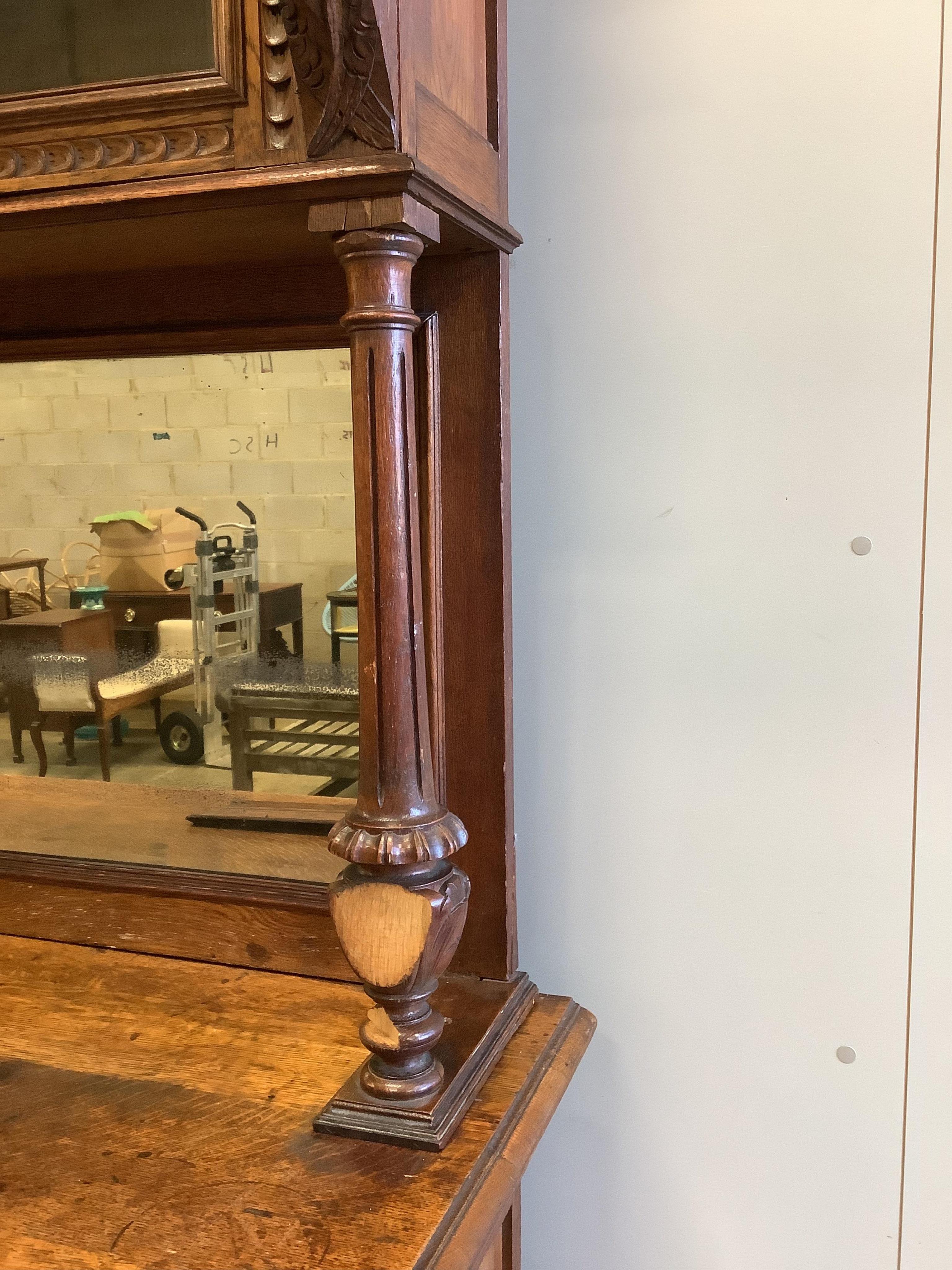 A 19th century Flemish carved oak buffet, width 139cm, depth 54cm, height 214cm. Condition - fair, two pieces of moulding detached but present